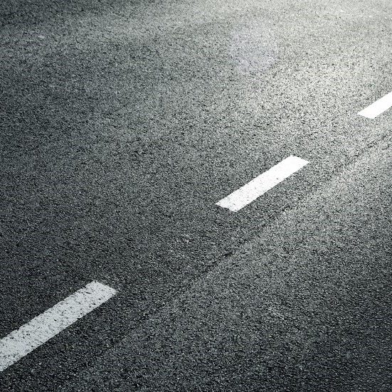 White dotted line on city asphalt road background.